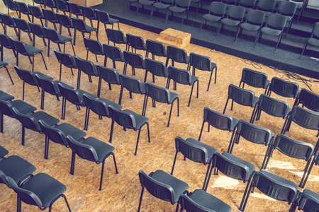 Empty chairs in the assembly hall are arranged in rows, top view