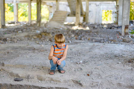 Poor and dirty street children living on an abandoned construction site.の写真素材
