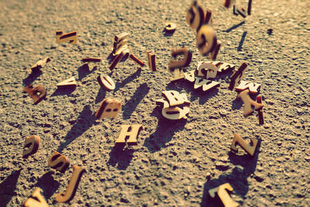                      Letters fall on the asphalt, tinted photo of the English alphabet, learning and...