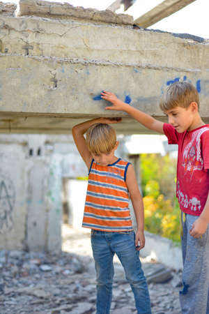Poor and dirty street children living on an abandoned construction site. a concept of the life of street children orphans.の写真素材