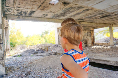 Poor and dirty street children living on an abandoned construction site.の写真素材