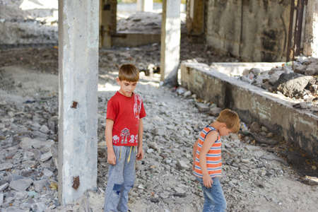 Poor and dirty street children living on an abandoned construction site. a concept of the life of street children orphans.の写真素材