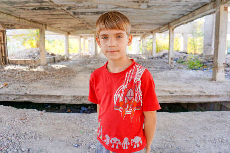 A dirty and hungry boy in an abandoned building in search of asylum.の写真素材