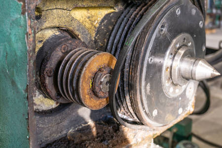 Replacing drive belt for the headstock of the machine spindle, a rusty pulley and a new belt.