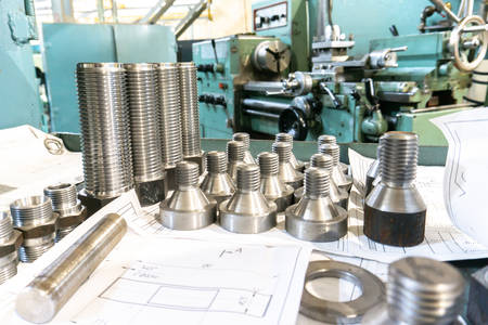 Bolts and screws with drawings after manufacturing on a lathe in machine building.