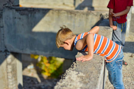 Poor and dirty street children living on an abandoned construction site.の写真素材