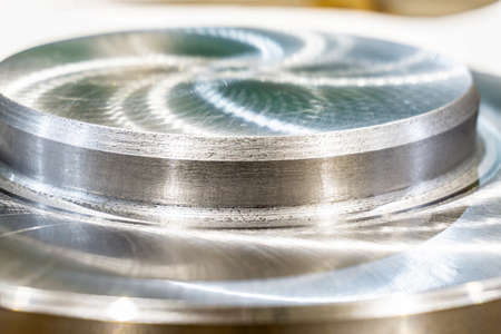 The polished part of the machined surface of a round metal part.の写真素材