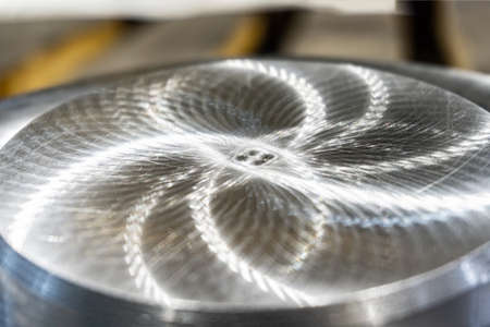 The polished part of the machined surface of a round metal part.の写真素材