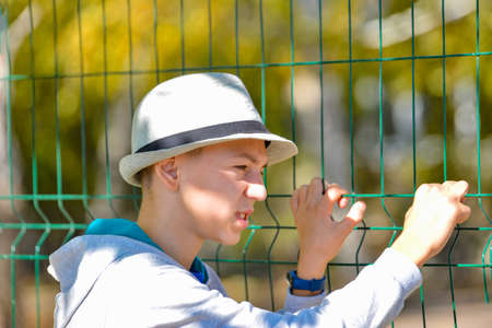 Portrait of an angry and displeased young man in a gray hat.の写真素材