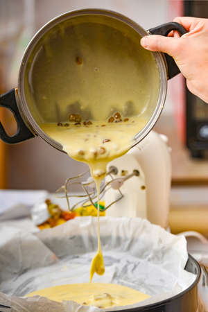 Mistress is being poured out of the pan, the pie dough is being poured into baking dishes.の写真素材