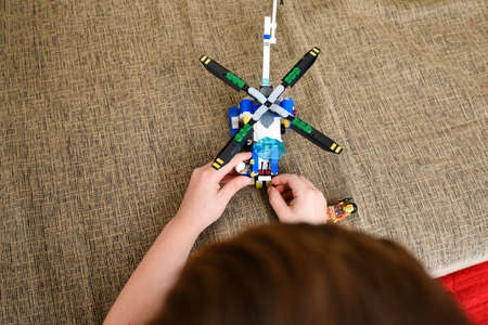 A boy plays in a children's toy helicopter from the designer.の写真素材