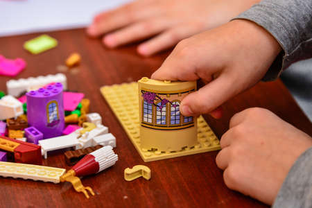 Children play in a children's designer and build different figures from it.