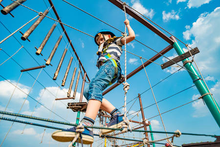 A boy in extreme park overcomes obstacles on the cable car.の写真素材
