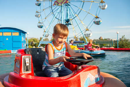 The boy rides on water transport in an extreme recreation parkの写真素材
