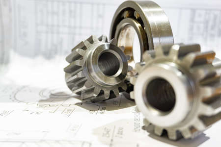 The gear after manufacturing on the gear cutter lies on the technical drawingの写真素材