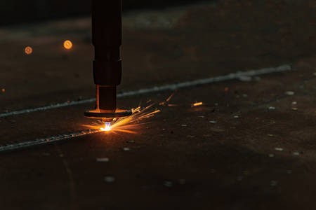 Plasma laser cutting on a cnc thick metal sheet, melting metal closeup