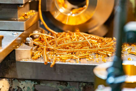 Yellow chips on the bed after processing bronze on a cnc latheの写真素材