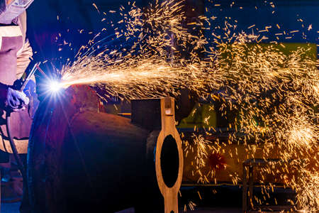 Welding with a graphite electrode, a lot of sparks fly in different directions. Fireworks from the...
