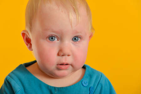 A sad and offended little child cries with tears in his eyes.の写真素材