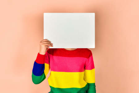Girl holding a blank poster for inscription and text.の写真素材