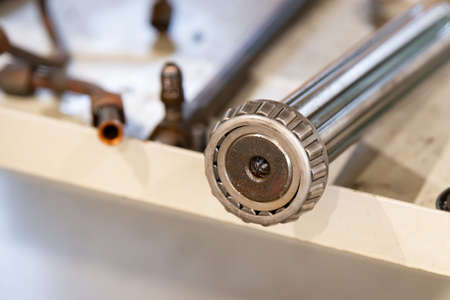 Splined shaft with bearing on the rack after the repair of the machine.