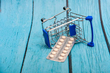 Inverted trolley and pills and medicines lie nearby, the concept of the uselessness and futility of treatment.の写真素材