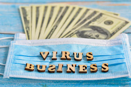 The concept of earning on a coronavirus. Protective mask and dollars.