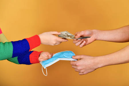 Clandestine sale of medical protective masks for dollars. Protection against coronavirus, virus, flu, infections.の写真素材