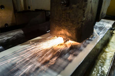 Metal rings on a magnetic plate on a surface grinding machine, grinding is carried out with a...