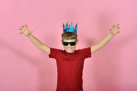 The boy in the crown on his head raised his hands to the top, the concept of fear and capture of the...