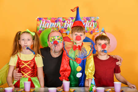 Dad celebrates a birthday with fairy clowns.の写真素材