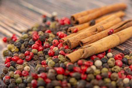 Cinnamon and spices in bulk lie on a dark wooden backgroundの写真素材