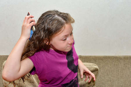 An angry girl, outraged by a telephone conversation, waving her arms