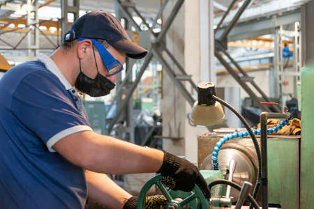 A worker worries about his safety during quarantine while wearing an anti-covid 19 mask. A turner...