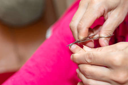 Mom cuts the child's fingernails with small children's scissors. Care and guardianship of children...