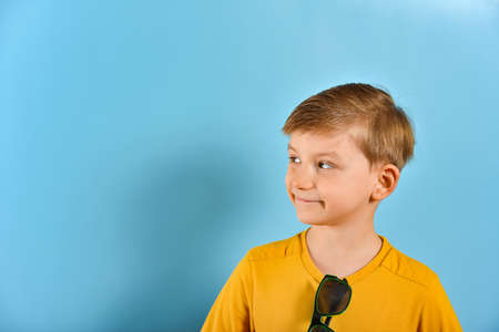 A boy with an expressive face looks sideways.の写真素材