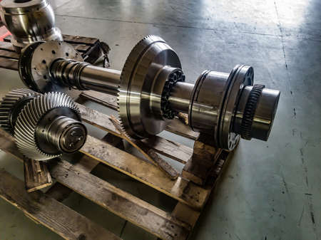 Disassembled gearbox after repair on a wooden rack in a workshop