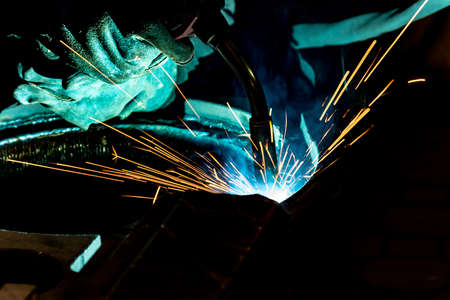 Metal welding worker at work in an electromechanical workshop.の写真素材