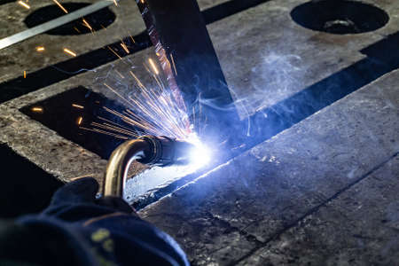 Electric gas welding in the workshop. Sparks from welding.