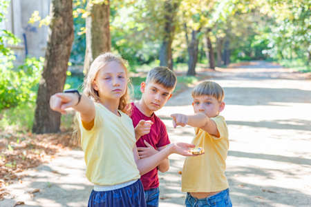 Children in the park are looking for compass directions.の写真素材