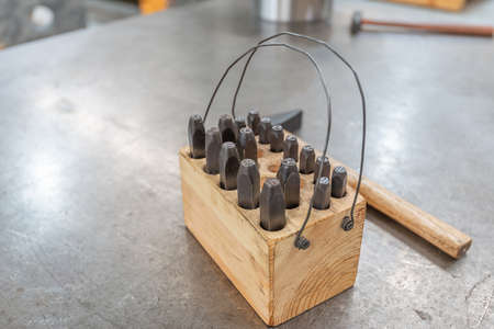 Hammer and core tool for marking metal products in production.