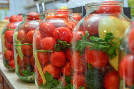 Pickled tomatoes in 3-liter bottles for long-term storage in the cellarの写真素材