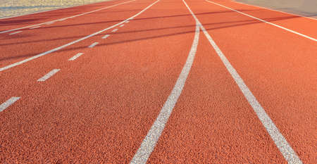 A red running stadium with white stripes for athletics
