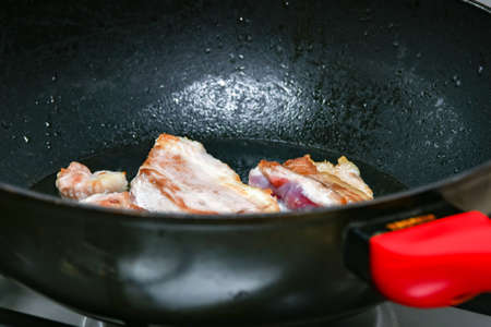 The loin of pork tenderloin is fried in a pan.の写真素材
