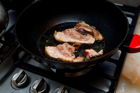 The loin of pork tenderloin is fried in a pan.の写真素材