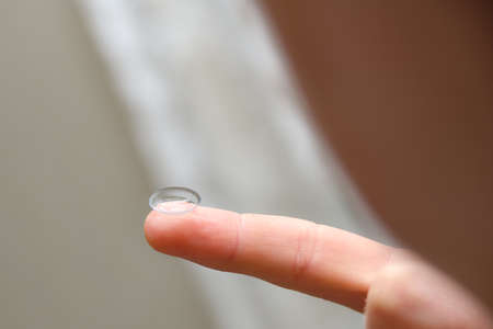 Contact lens close-up on the finger after use.の写真素材