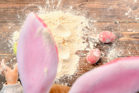 The child plays with flour and Easter eggs. Preparing children for Easter.の写真素材