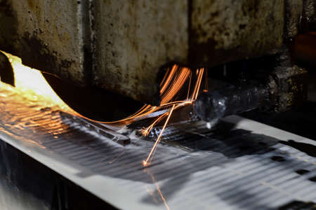 Sparks rotate on abrasive wheels when metal is processed on a surface grinder.の写真素材