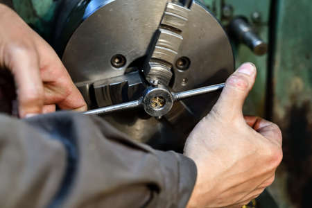A turner cuts a thread with a lathe on a lathe.の写真素材