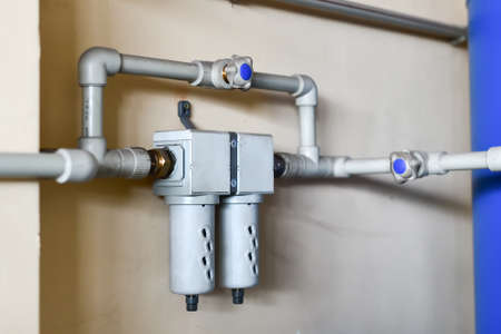 The fine filter of water supply is fed into one system, fixed on the wall.の写真素材